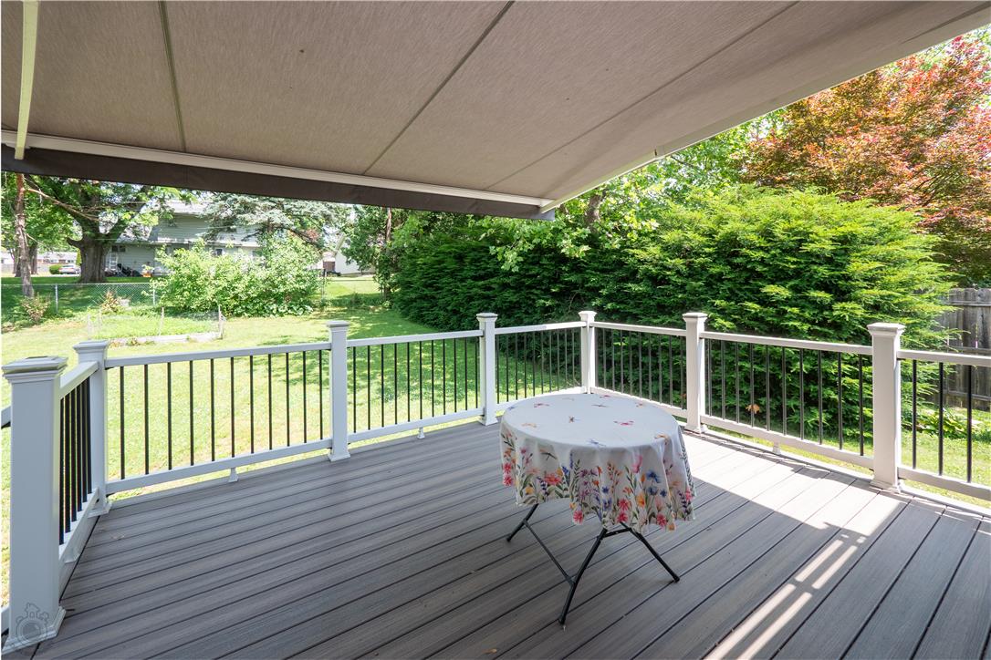 2439 Congress Street Allentown, PA 18104 - Photo 21 of 34 An inviting deck, complete with a retractable awning, overlooks a verdant backyard, perfect for outdoor relaxation.