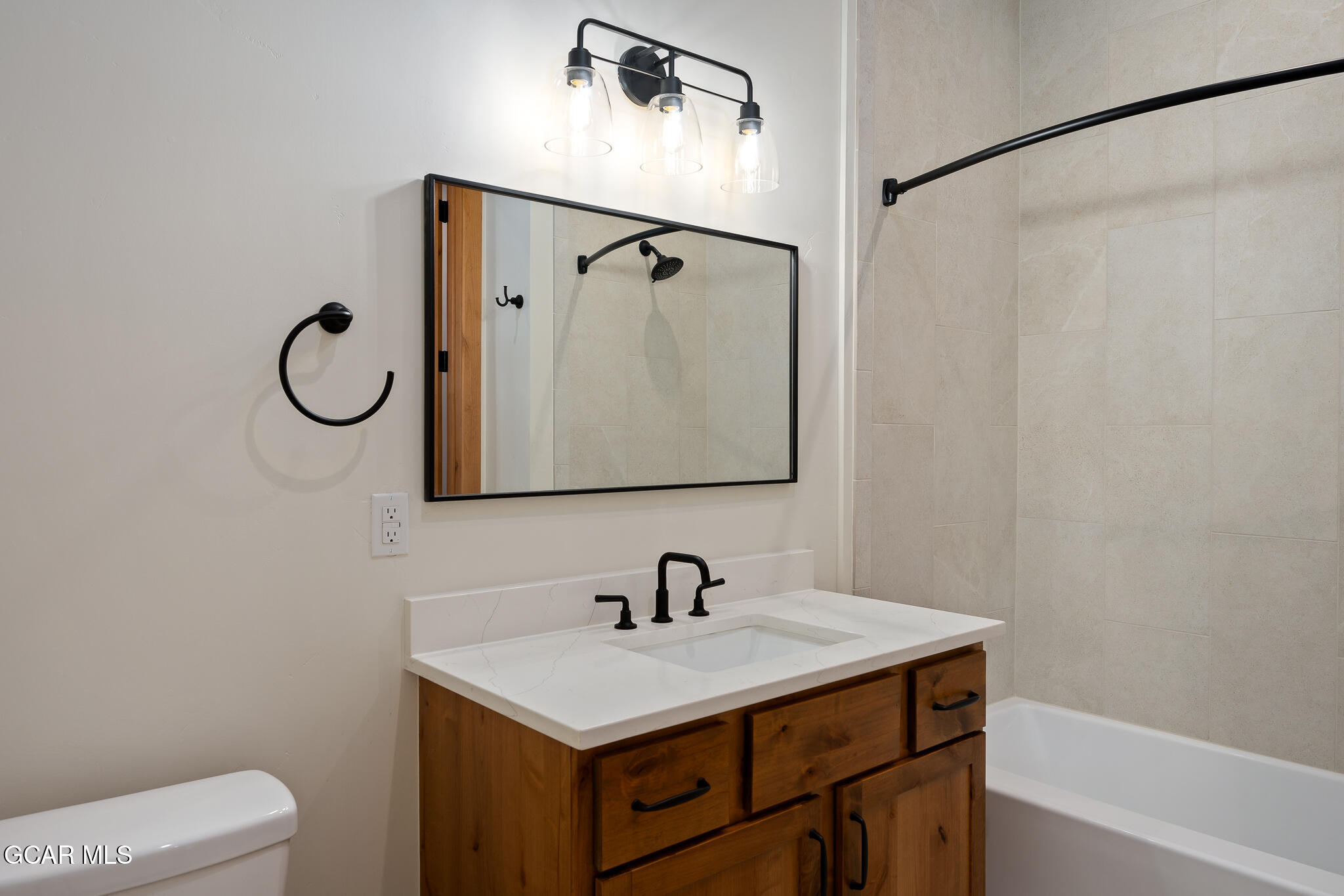72 Meadow Trail, Unit F101 Fraser, CO 80442 - Photo 11 of 19 a bathroom with a sink vanity mirror and toilet