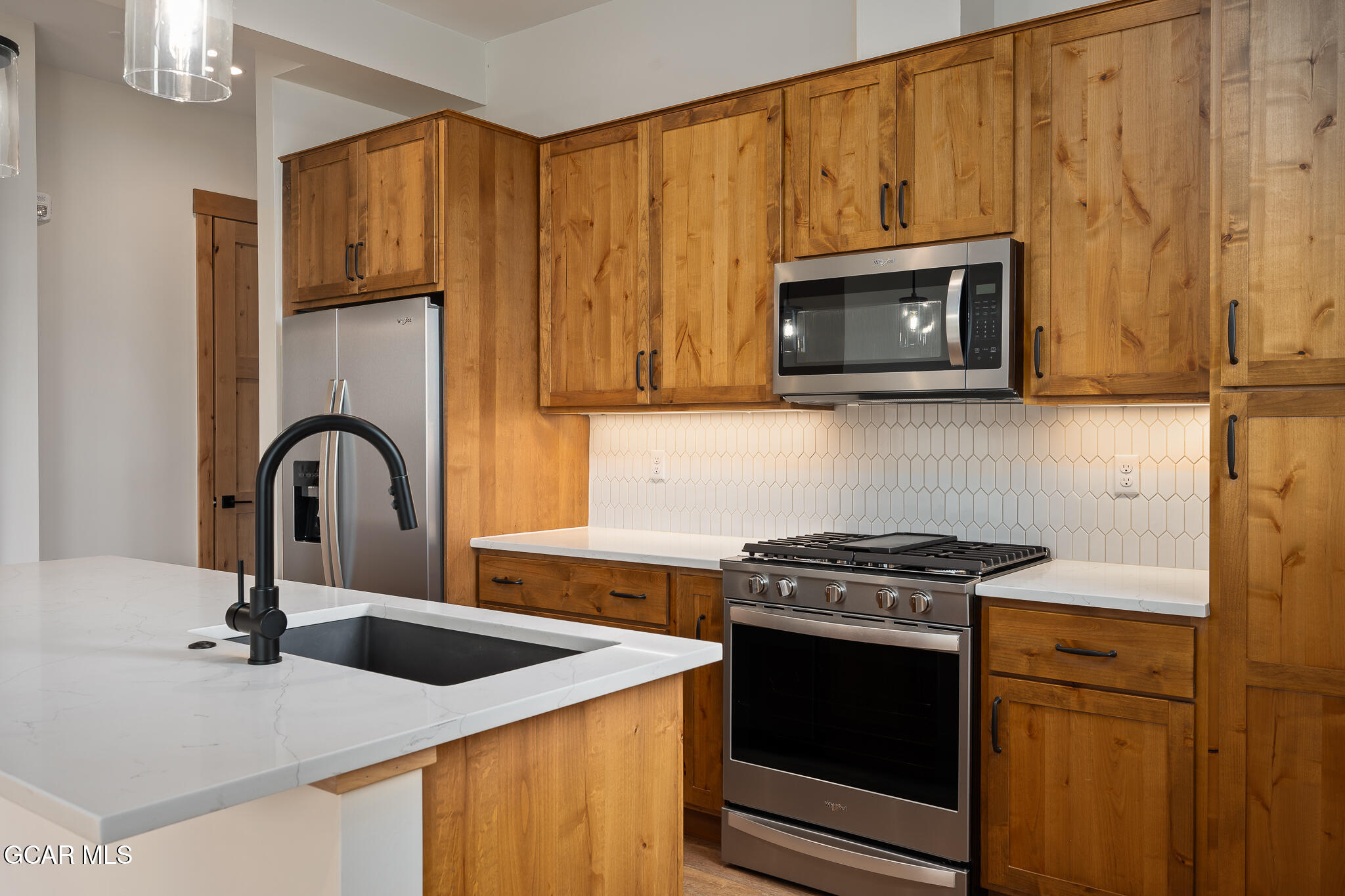 72 Meadow Trail, Unit F101 Fraser, CO 80442 - Photo 3 of 19 a kitchen with stainless steel appliances granite countertop a stove a microwave and a sink