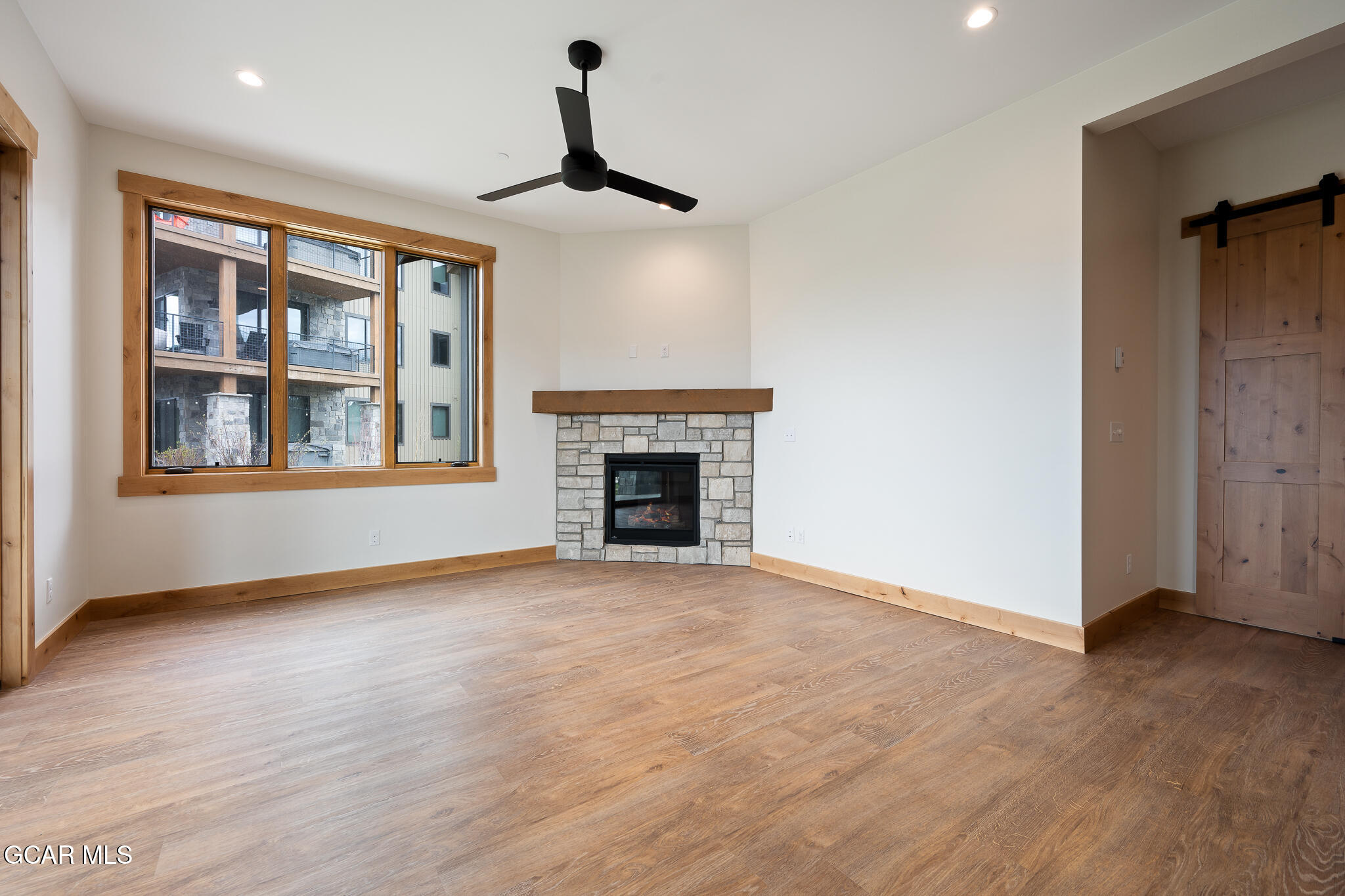 72 Meadow Trail, Unit F101 Fraser, CO 80442 - Photo 6 of 19 a view of an empty room with window and wooden floor