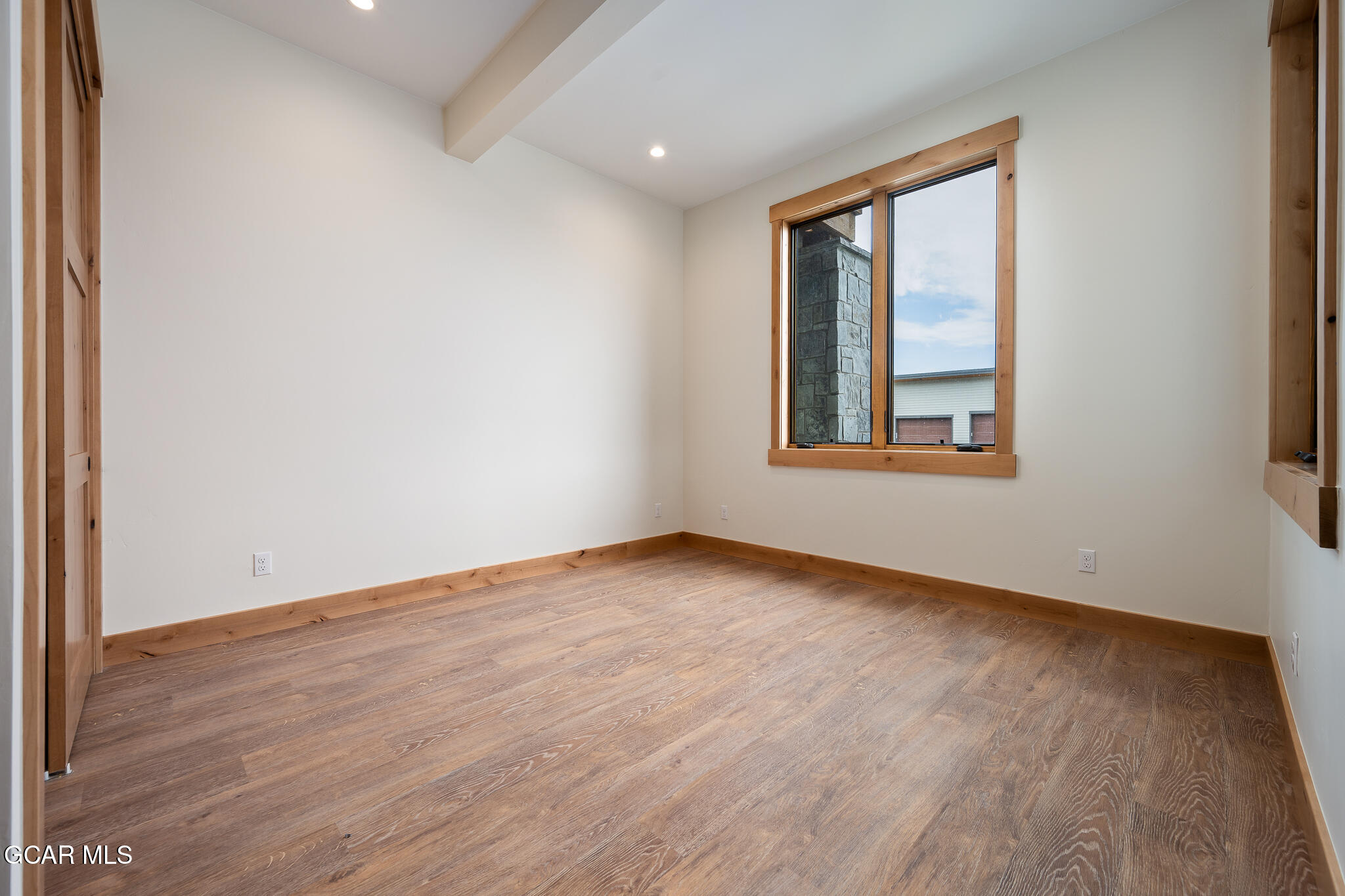 72 Meadow Trail, Unit F101 Fraser, CO 80442 - Photo 8 of 19 an empty room with wooden floor and windows