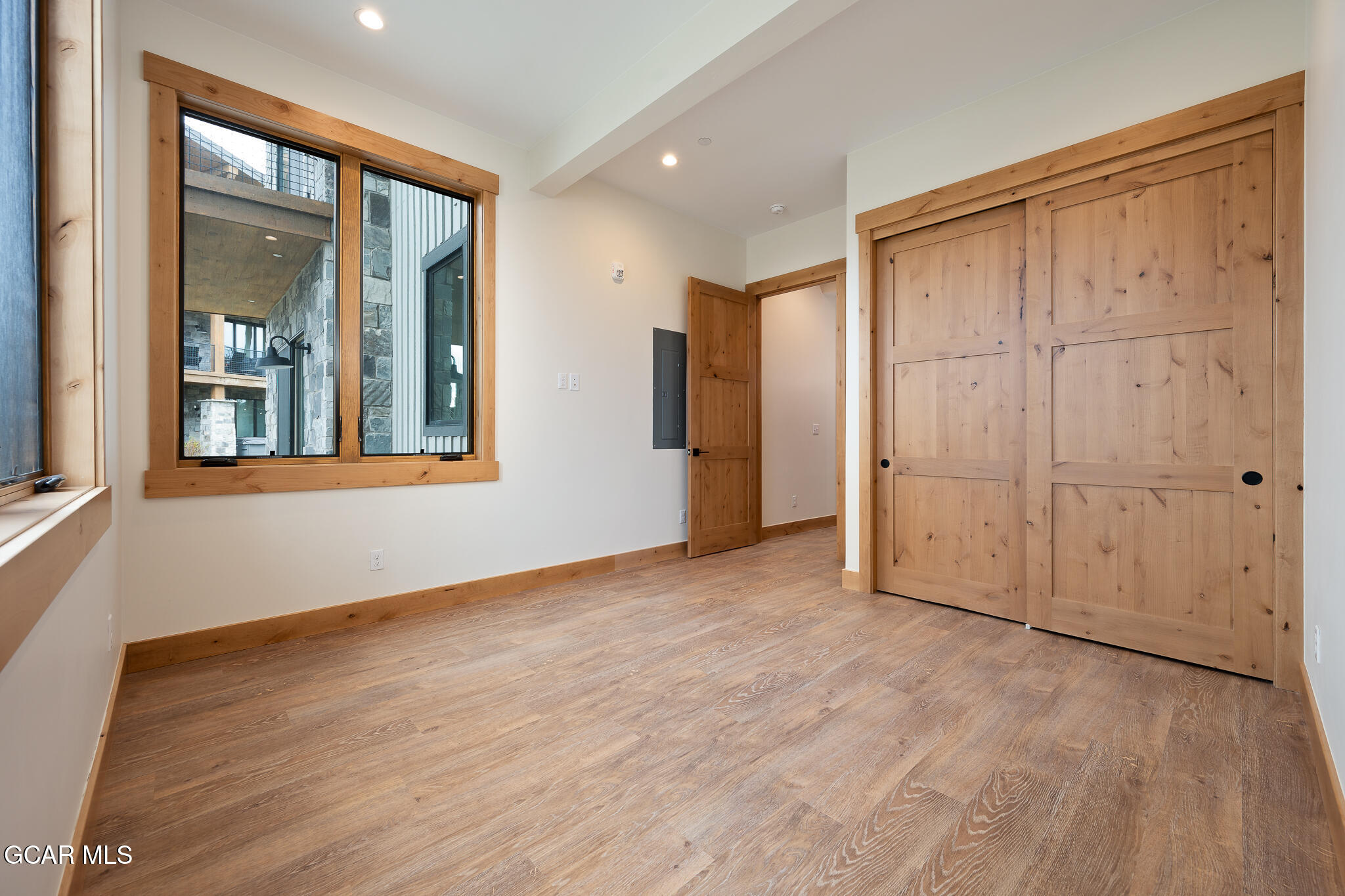 72 Meadow Trail, Unit F101 Fraser, CO 80442 - Photo 9 of 19 a view of an empty room with wooden floor and a window