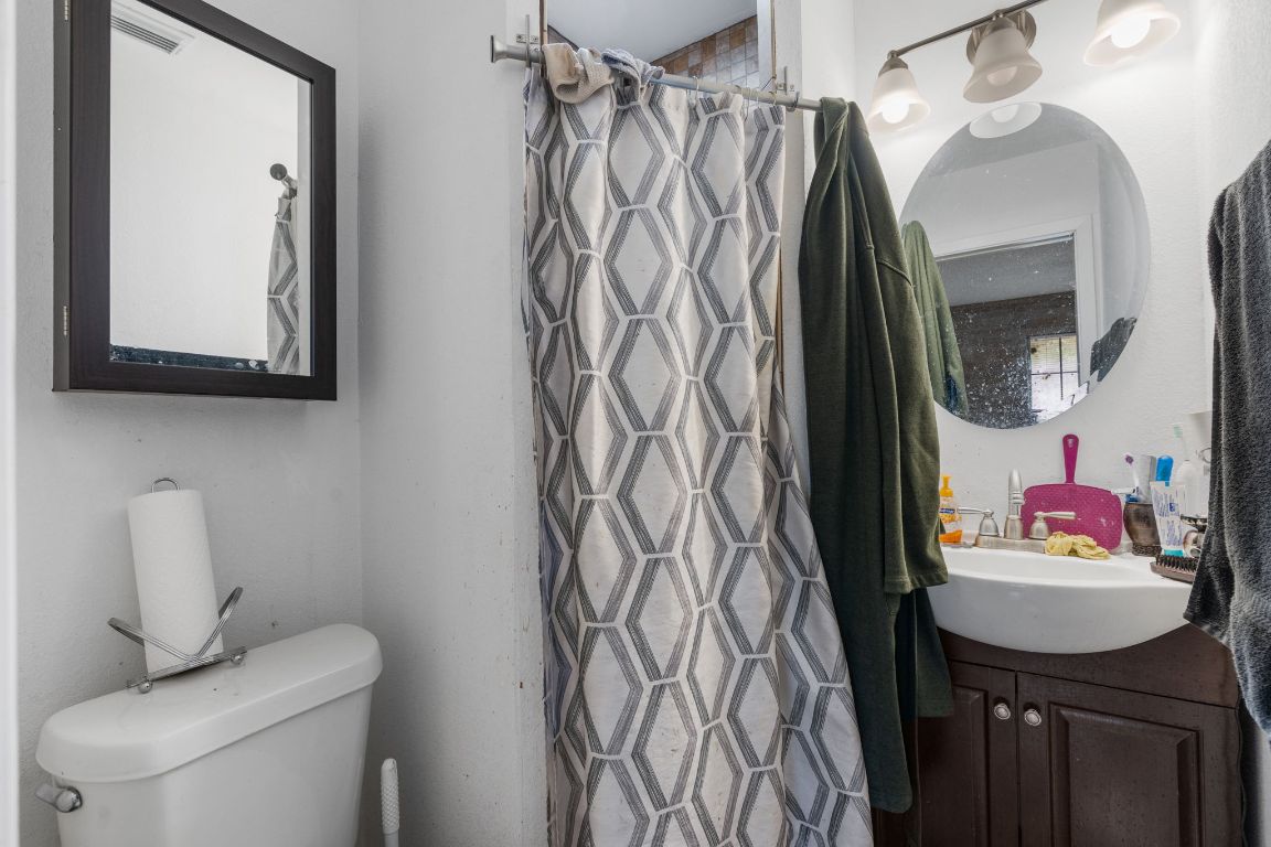 950 County Road 481 Thrall, TX 76578 - Photo 17 of 25 a bathroom with a toilet sink and mirror