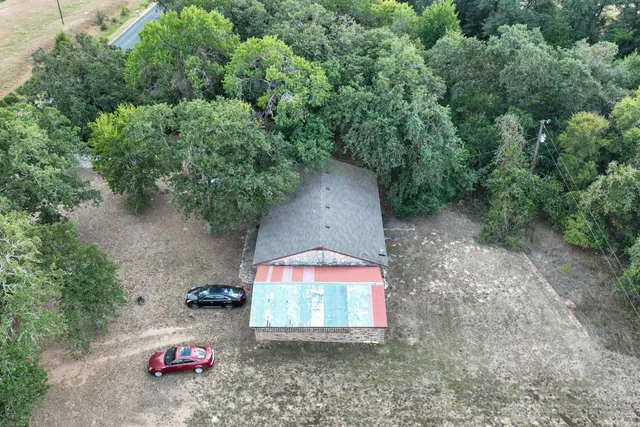 an aerial view of a house with outdoor space