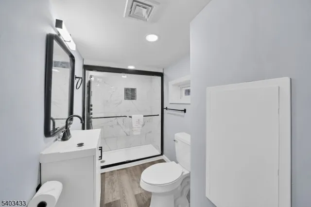a white toilet sitting next to a bathroom sink