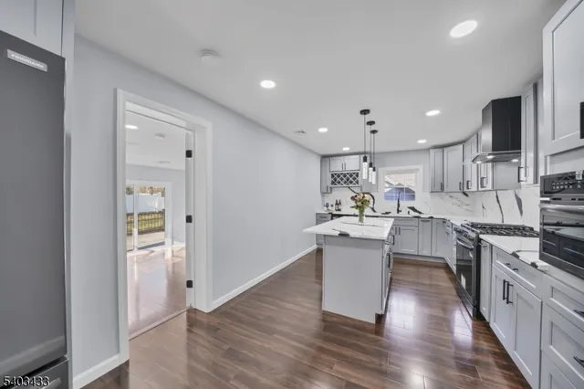 a kitchen with a sink and stainless steel appliances