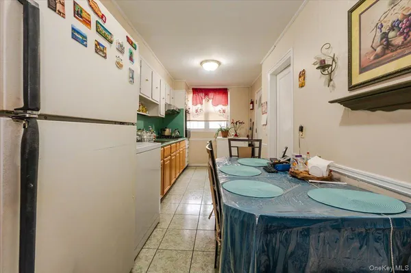 a bedroom with a bed and dresser with mirror