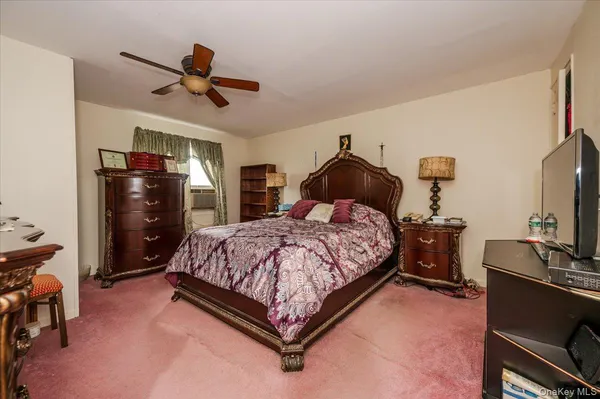 a bedroom with bed and wooden floor