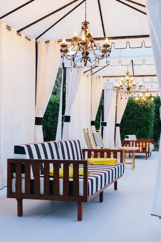 a view of a swimming pool with a bench and tables