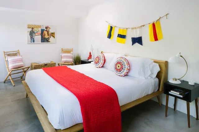 a bedroom with a bed and painting on the wall