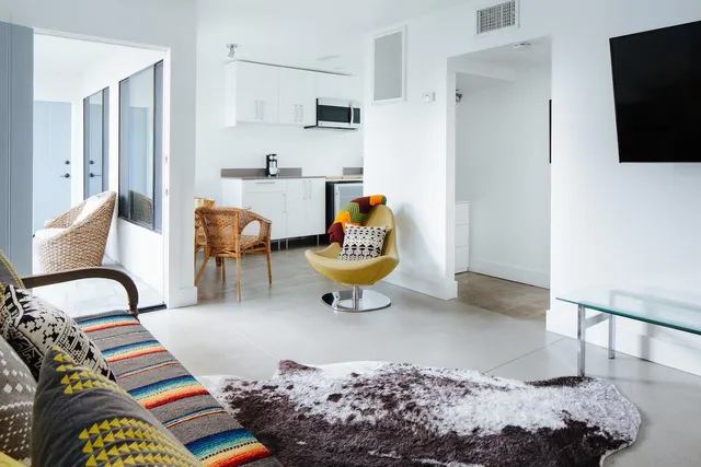 a bedroom with furniture and a flat screen tv