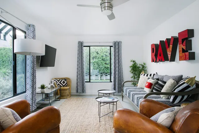 a living room with furniture fireplace and a window