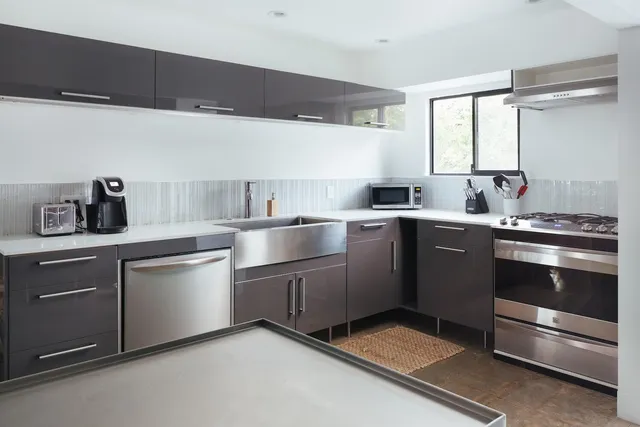 a kitchen with a sink stove and cabinets