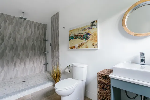 a bathroom with a toilet a sink and shower