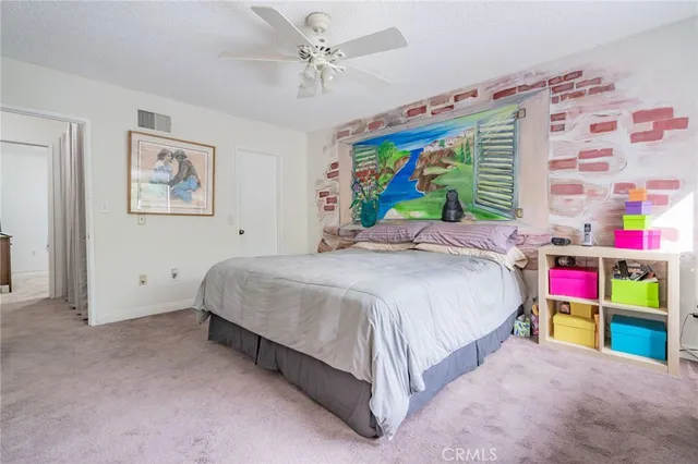 a bed room with a bed and a painting on the wall