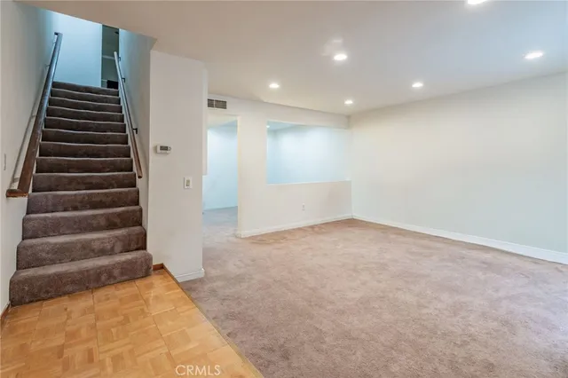 a view of an empty room with stairs