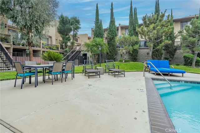 a view of outdoor space with swimming pool and lounge chair