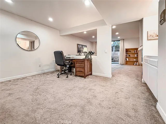 an outdoor sitting area with furniture and wooden fence