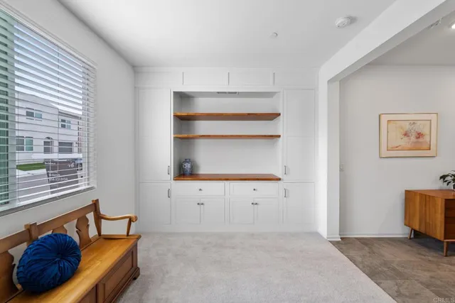 a view of staircase with lots of frames on wall and wooden floor