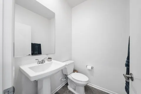 a view of a hallway with windows and lounge chair