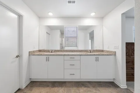 a walk in closet with view of bedroom