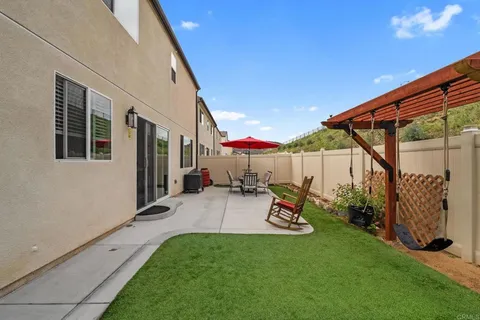 a view of a patio with table and chairs potted plants with wooden floor