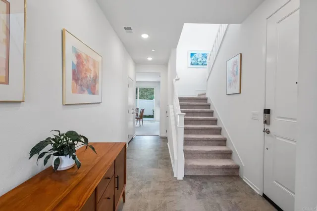 a kitchen with granite countertop a refrigerator oven a sink and cabinets