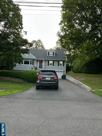 a car parked in front of a house and a yard