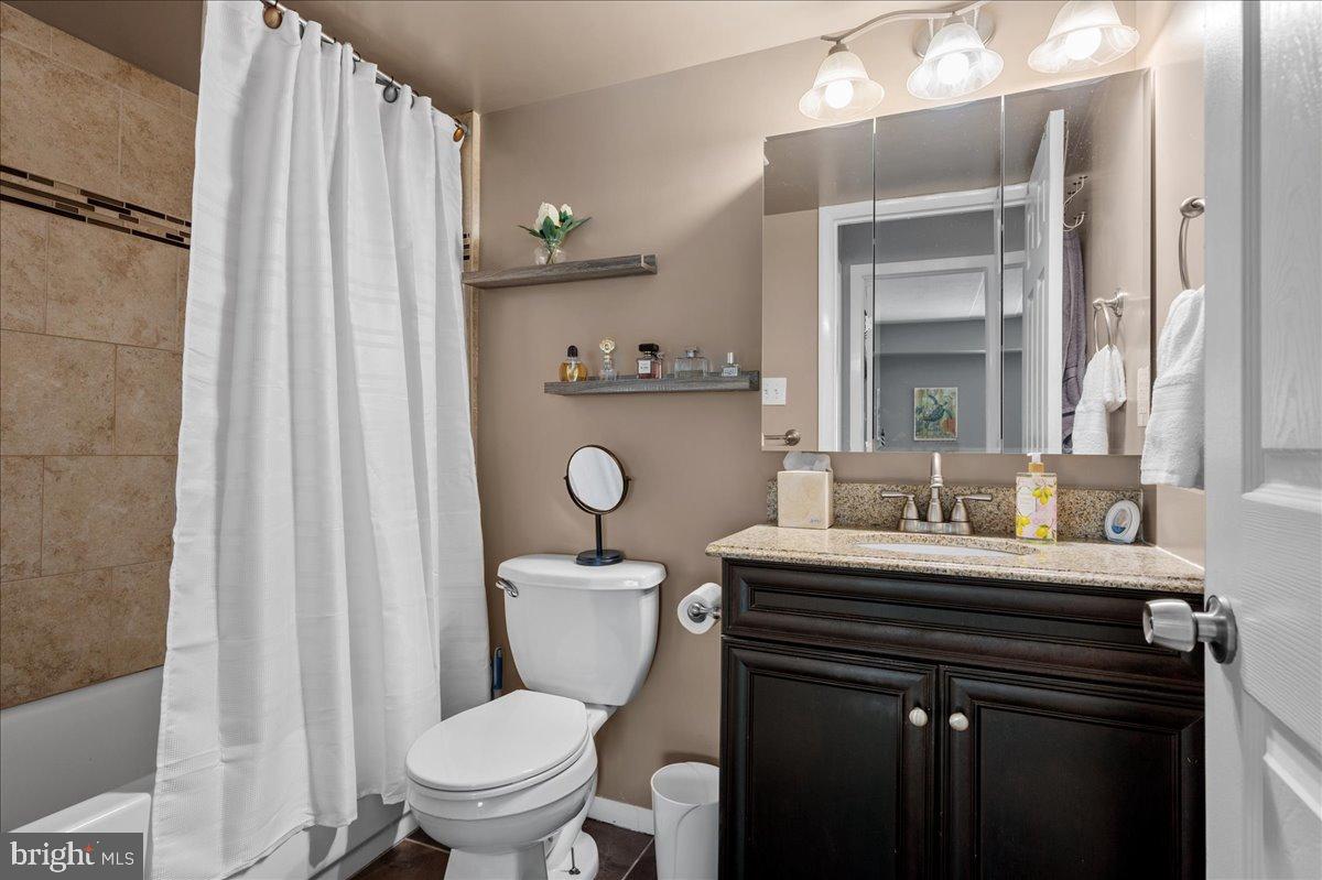 84 Welsh Tract Road, Unit 106 Newark, DE 19713 - Photo 15 of 32 a bathroom with a toilet a sink and a mirror