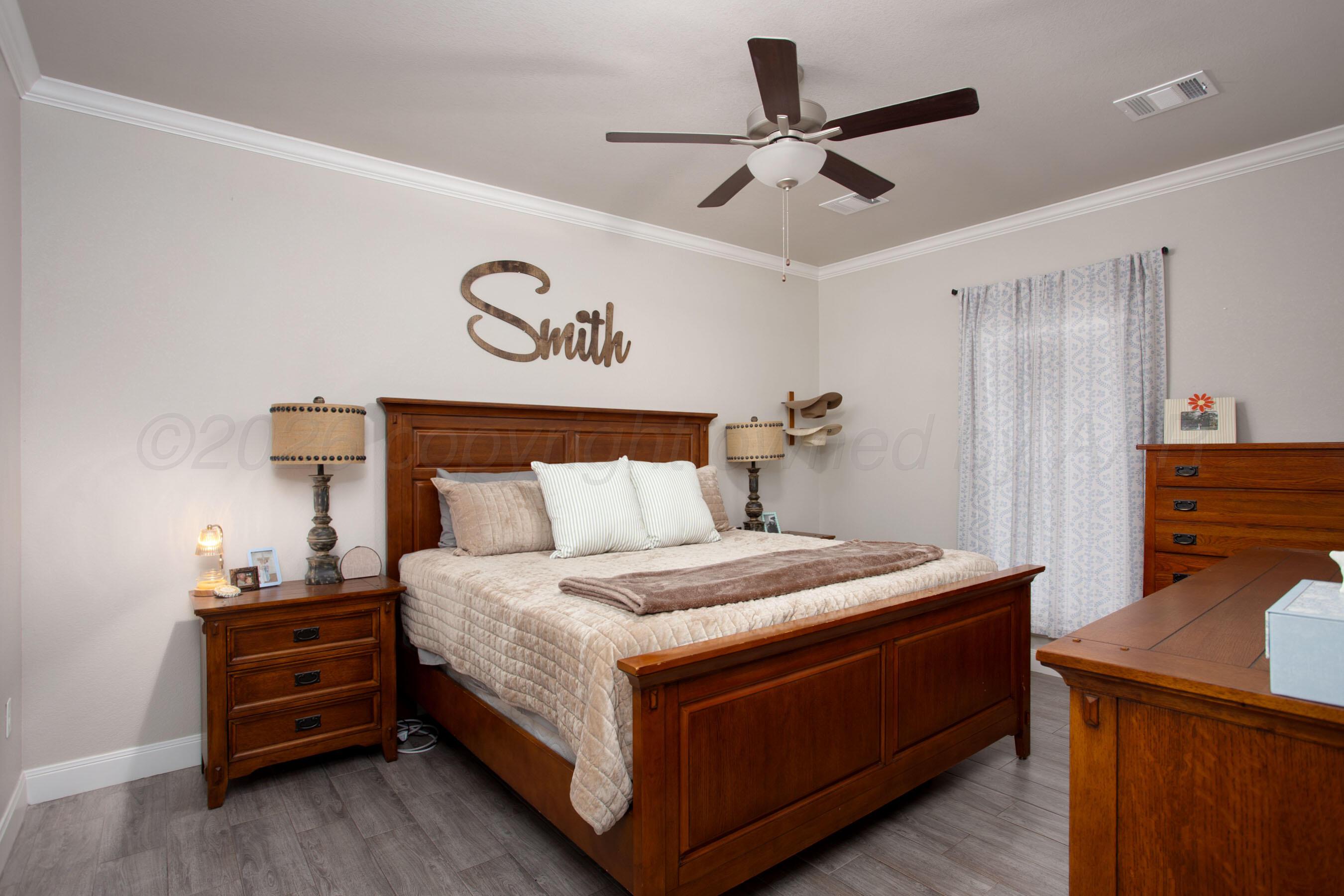 57 Cm Lane Canyon, TX 79015 - Photo 11 of 26 a bedroom with a bed and a chandelier