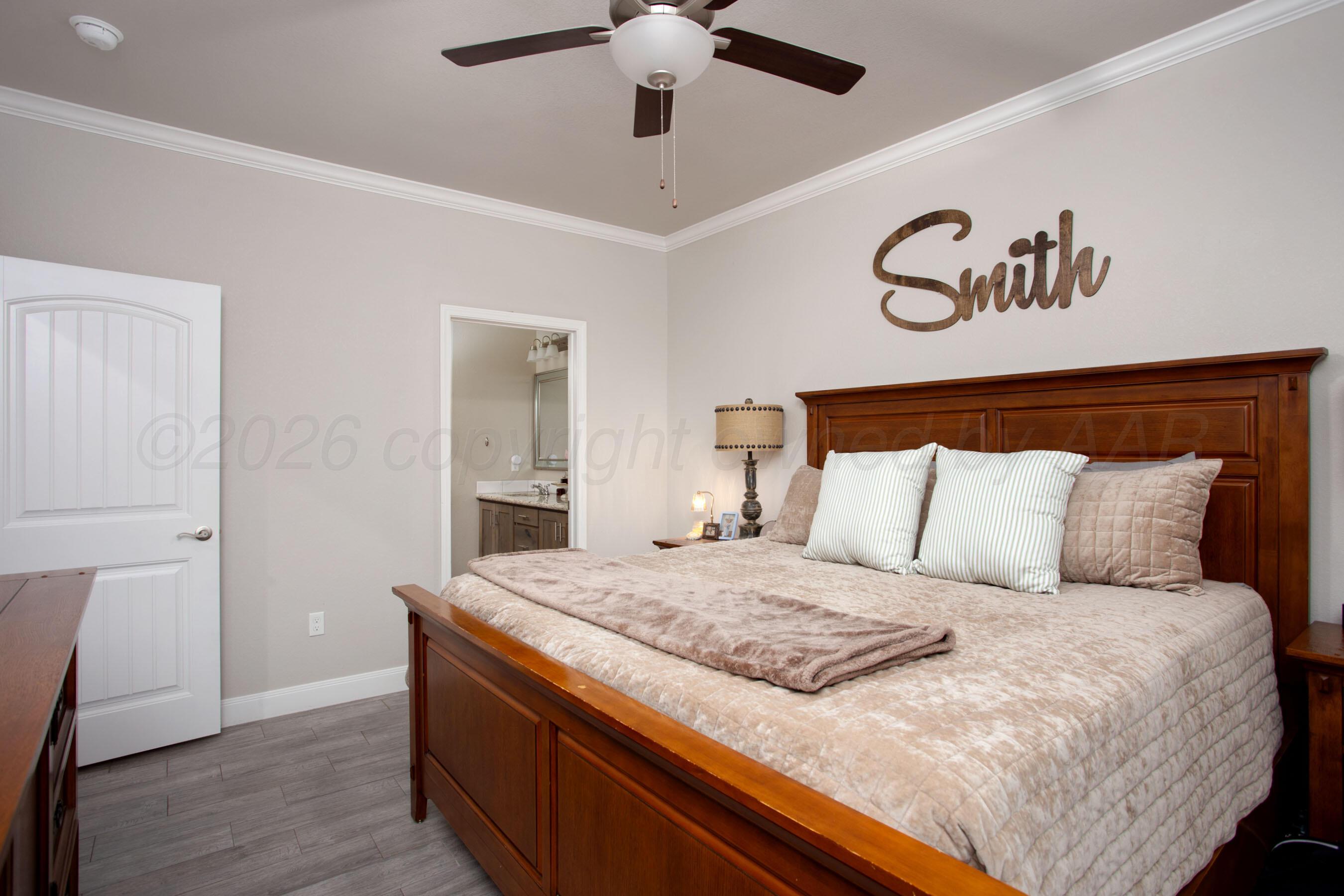 57 Cm Lane Canyon, TX 79015 - Photo 12 of 26 a bedroom with a large bed and a chandelier