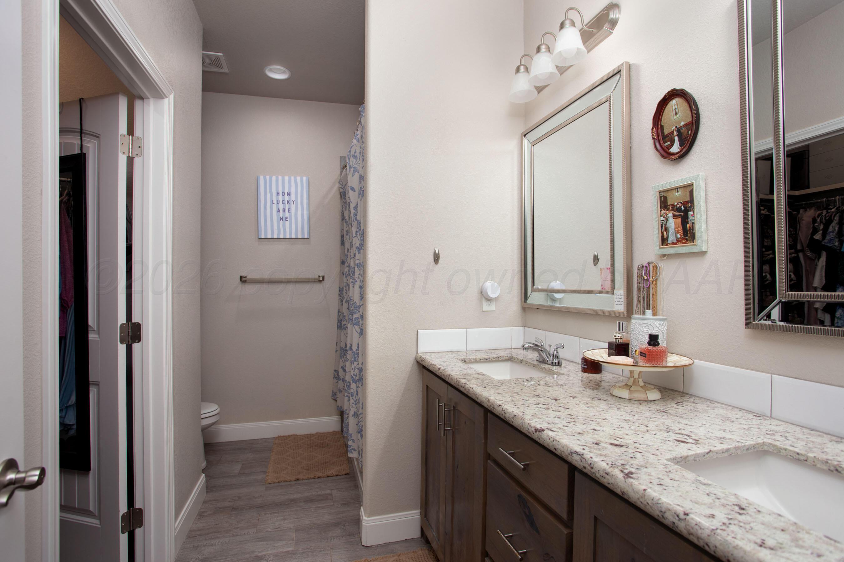 57 Cm Lane Canyon, TX 79015 - Photo 13 of 26 a bathroom with a granite countertop sink a mirror and a shower