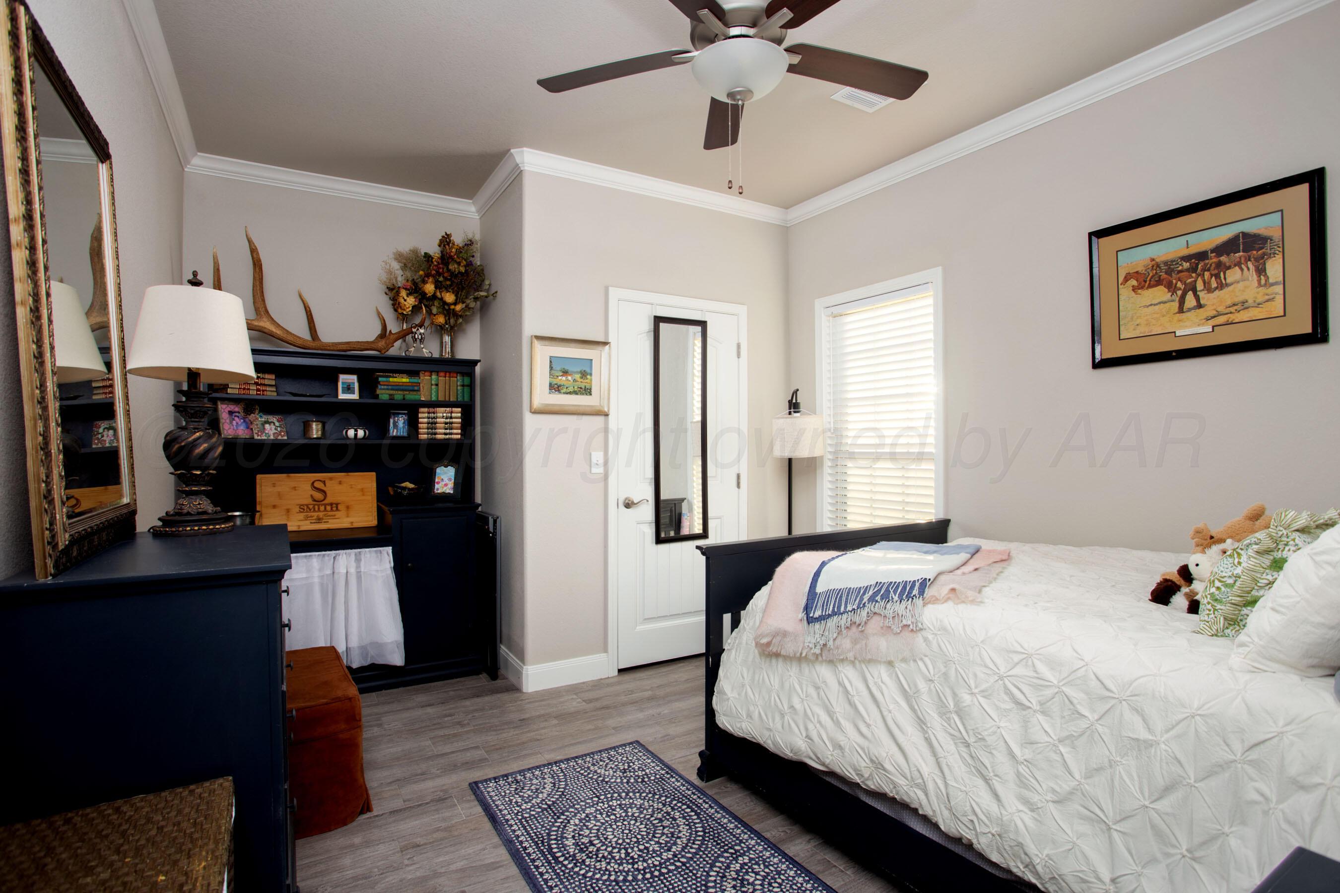 57 Cm Lane Canyon, TX 79015 - Photo 15 of 26 a bedroom with a bed and wooden floor