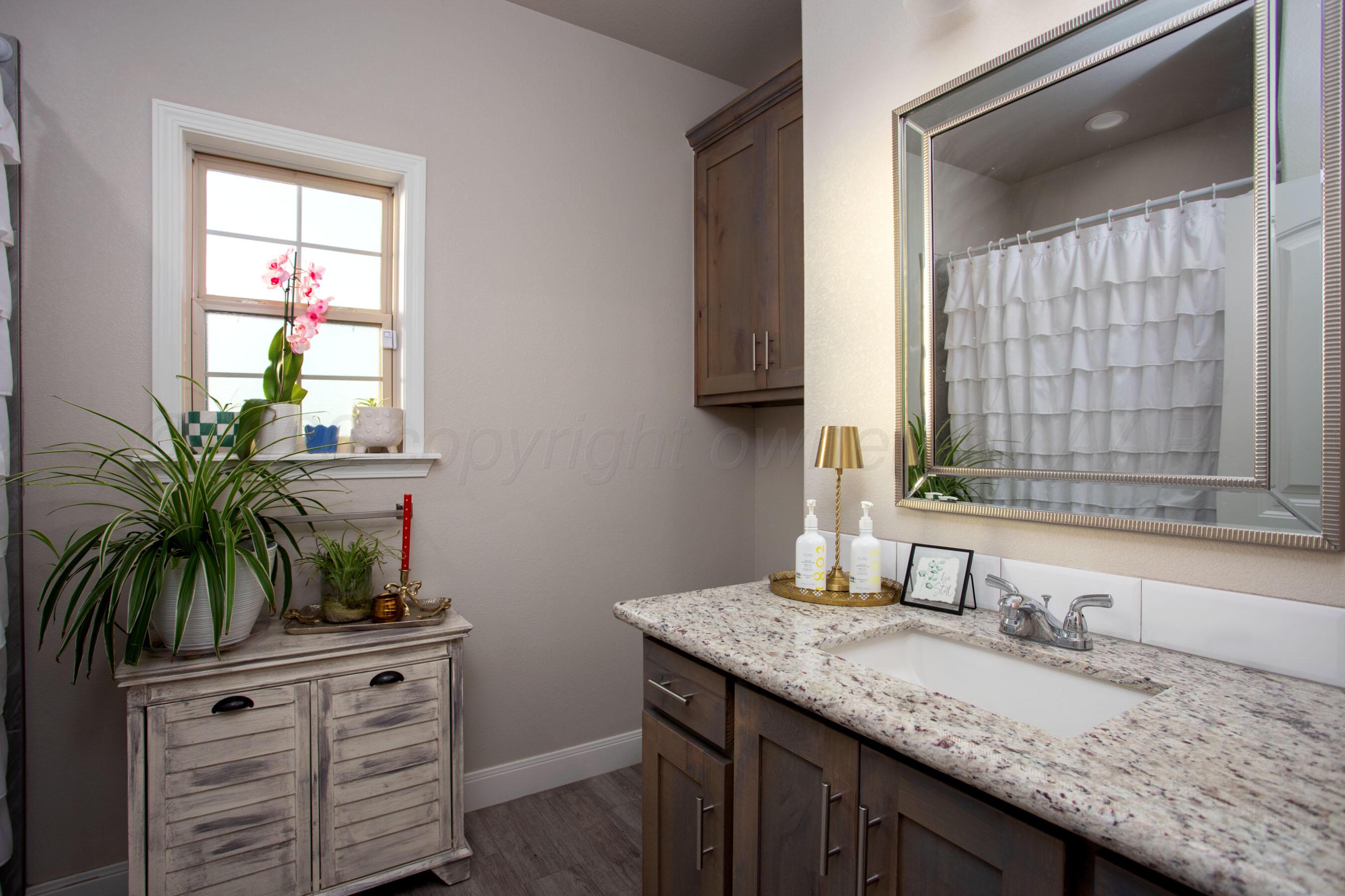 57 Cm Lane Canyon, TX 79015 - Photo 21 of 26 a bathroom with a granite countertop sink a mirror and a window