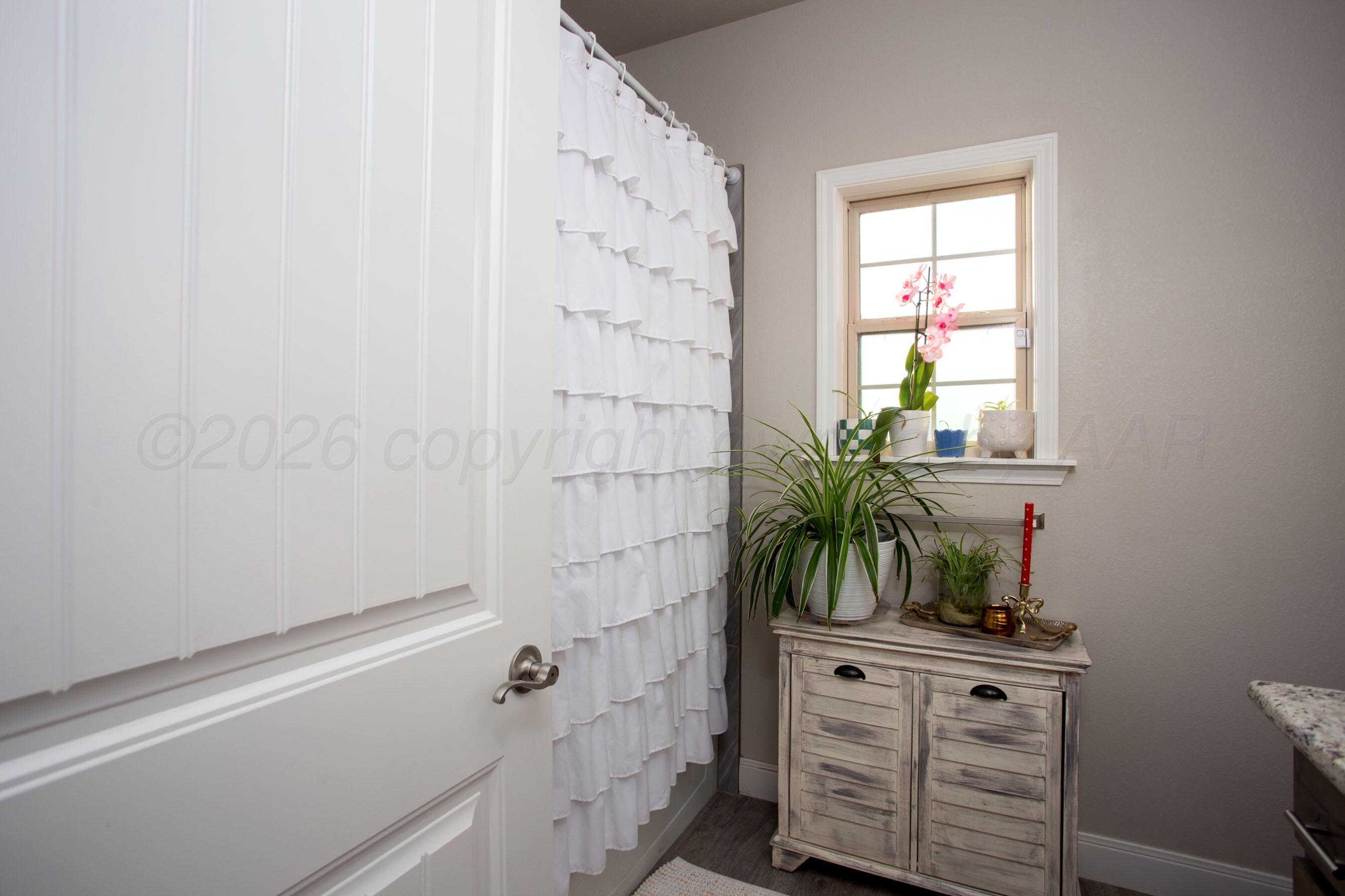 57 Cm Lane Canyon, TX 79015 - Photo 22 of 26 a bathroom with a shower curtain a mirror and a sink