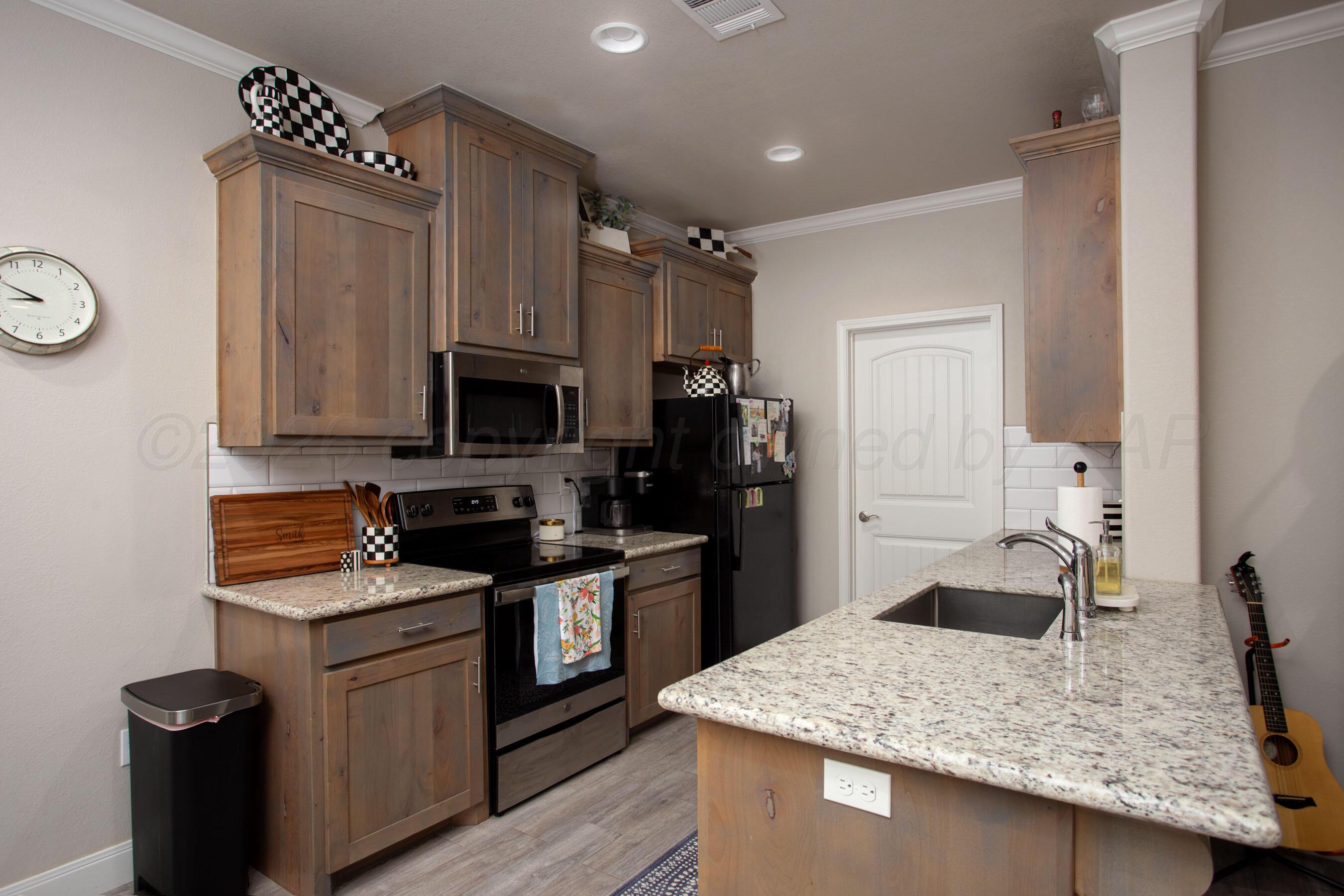 57 Cm Lane Canyon, TX 79015 - Photo 7 of 26 a kitchen with stainless steel appliances granite countertop a sink stove and refrigerator