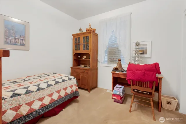 a bedroom with a bed and a chair