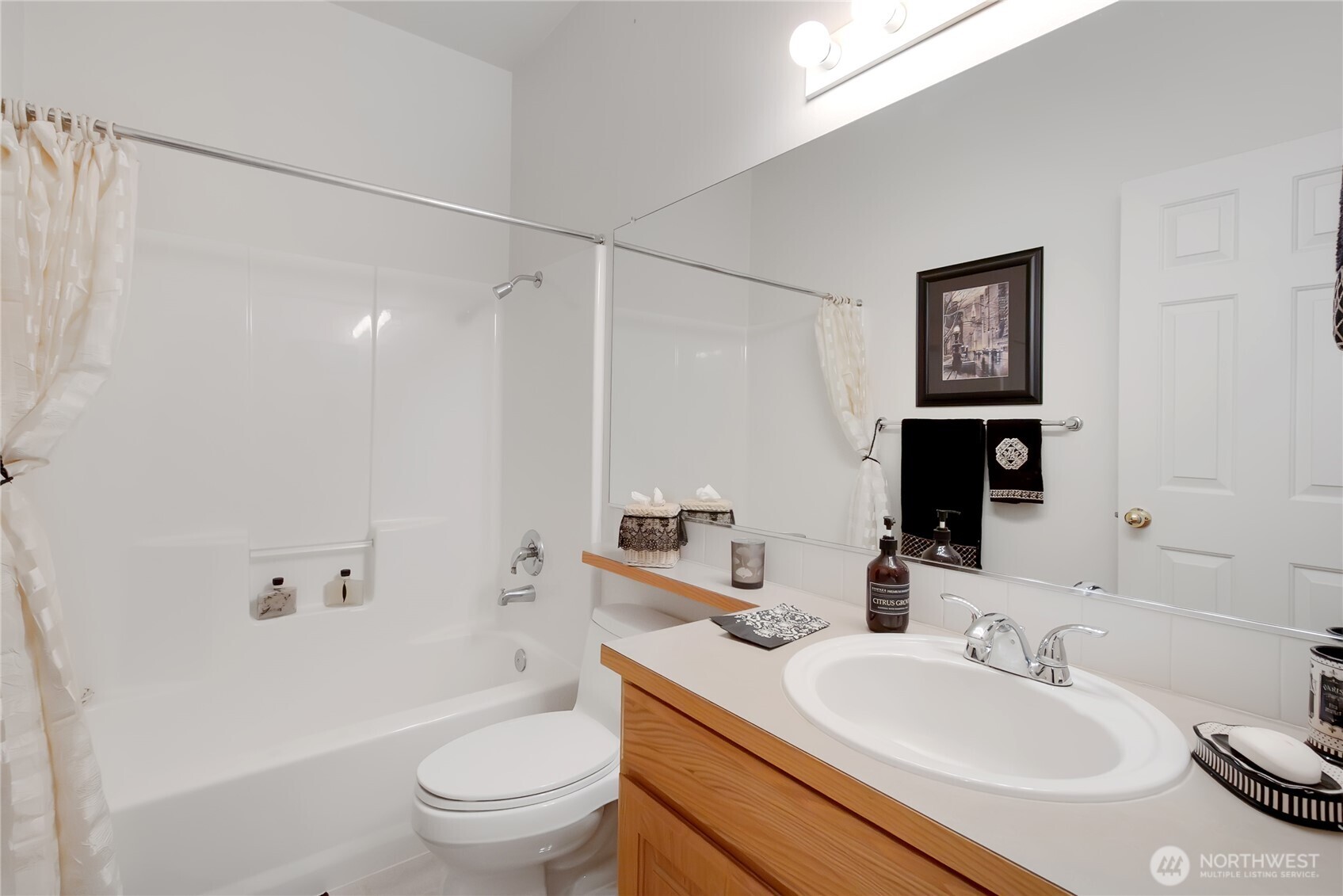 8235 Sweetbrier Loop Southeast Olympia, WA 98513 - Photo 14 of 24 a bathroom with a sink toilet and shower