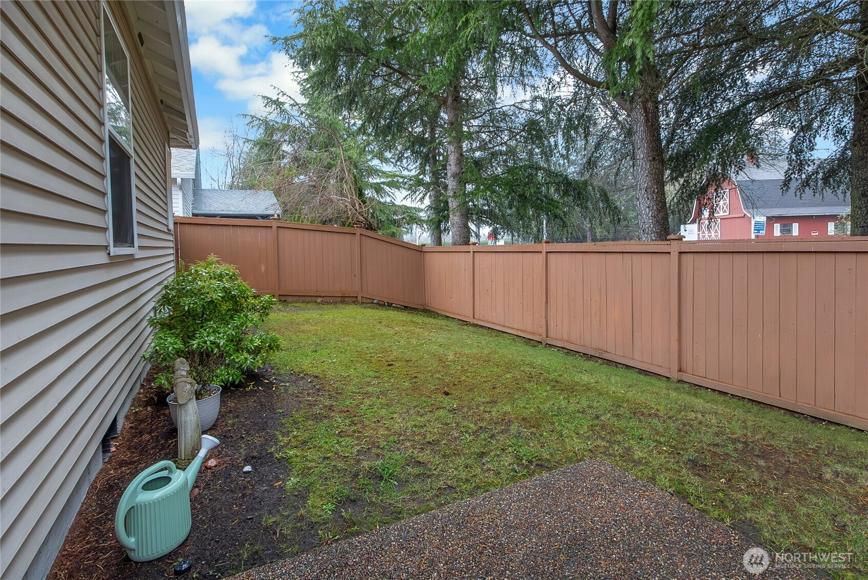 8235 Sweetbrier Loop Southeast Olympia, WA 98513 - Photo 18 of 24 a view of a backyard with potted plants and large trees