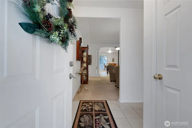 a hallway with a potted plant on the wall