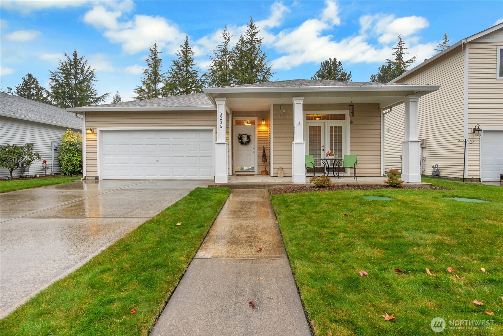 8235 Sweetbrier Loop Southeast Olympia, WA 98513 - Photo 24 of 24 a front view of a house with a yard and potted plants