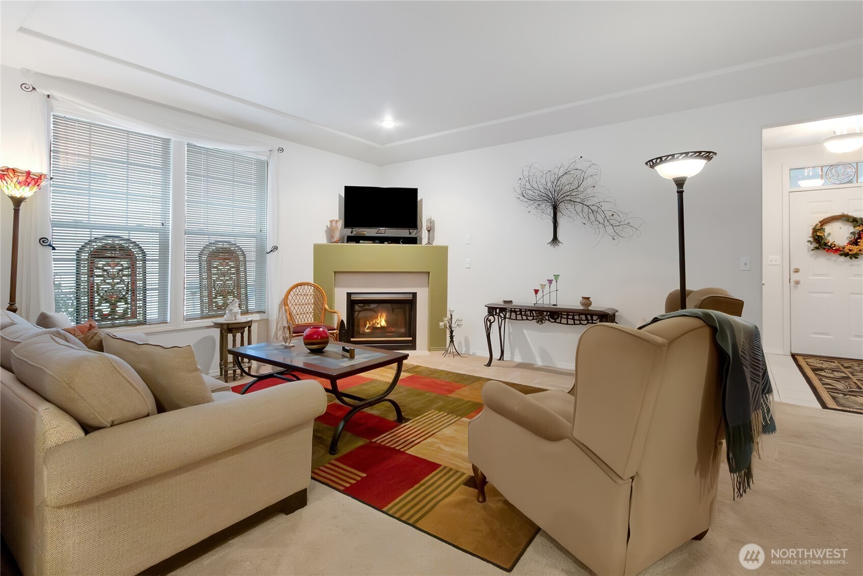 8235 Sweetbrier Loop Southeast Olympia, WA 98513 - Photo 5 of 24 a living room with furniture a flat screen tv and a fireplace