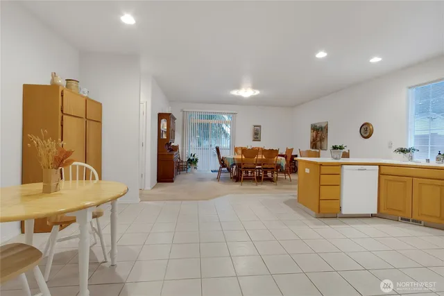 a living room with furniture a dining table and a stove top oven