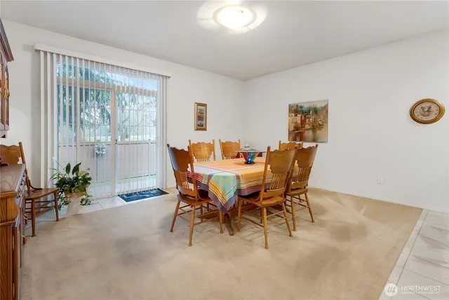 a view of a dining room with furniture and a potted plant