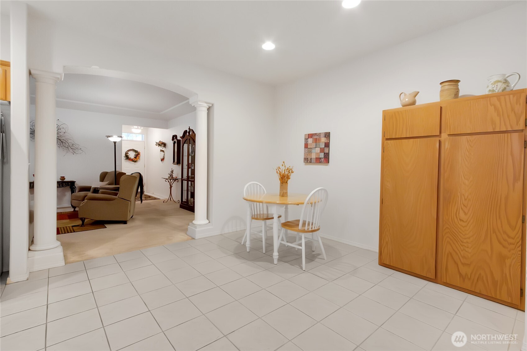 8235 Sweetbrier Loop Southeast Olympia, WA 98513 - Photo 10 of 24 a living room with furniture a refrigerator and a table