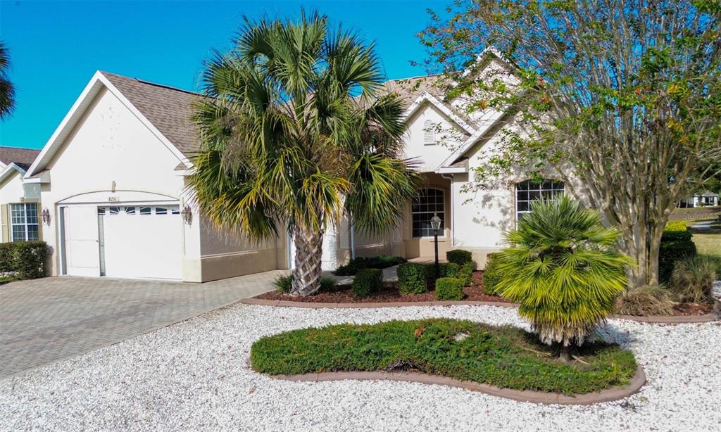 8251 Southwest 84th Place Road Ocala, FL 34481 - Photo 1 of 38 a front view of a house with garden