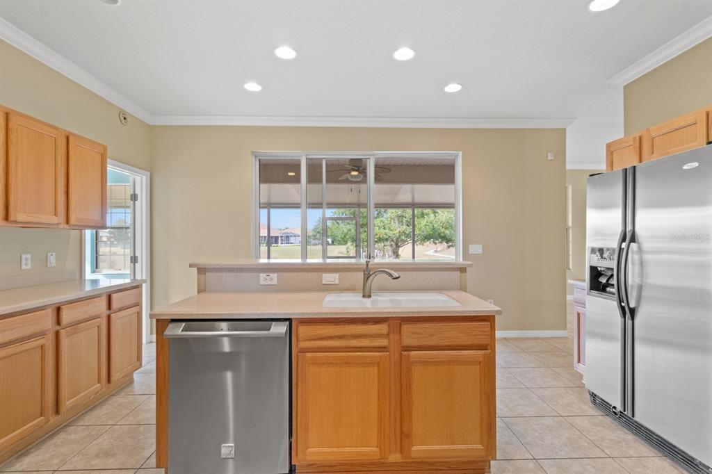 8251 Southwest 84th Place Road Ocala, FL 34481 - Photo 11 of 38 a kitchen with stainless steel appliances granite countertop a sink and a refrigerator