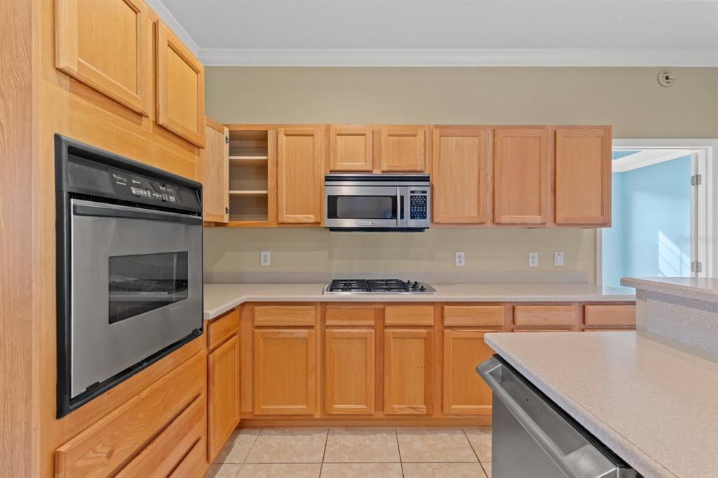8251 Southwest 84th Place Road Ocala, FL 34481 - Photo 12 of 38 a kitchen with stainless steel appliances granite countertop a sink and a microwave