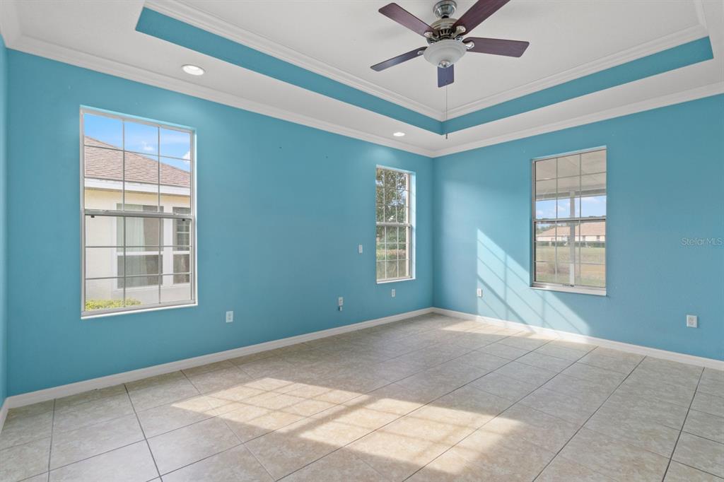 8251 Southwest 84th Place Road Ocala, FL 34481 - Photo 15 of 38 an empty room with windows and fan