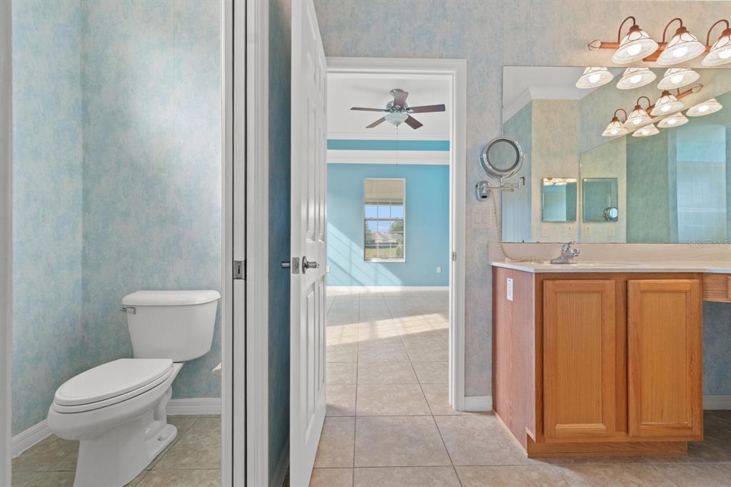8251 Southwest 84th Place Road Ocala, FL 34481 - Photo 18 of 38 a bathroom with a granite countertop sink mirror and toilet